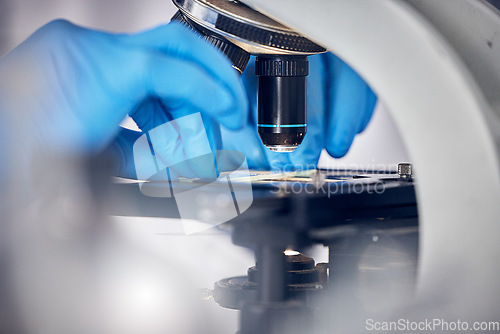 Image of Microscope, science and scientist hands, analysis of data or DNA sample, microbiology or biotechnology research study. Particles zoom, bacteria and doctor in laboratory for scientific innovation.