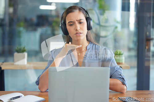 Image of Business woman, laptop and headphones for a webinar, video conference or video call on zoom in a office. Entrepreneur serious while talking at computer screen for training, learning or online meeting