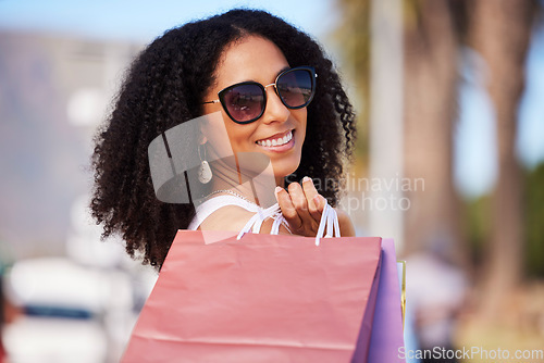 Image of Happy, retail and black woman with shopping bag portrait and smile in sunny Los Angeles, USA. Happiness, consumerism and trendy fashionista girl with shopping bags for stylish lifestyle.