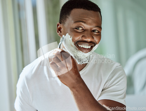 Image of Cream, razor and shaving black man in the bathroom for skincare, beard grooming routine and facial care. Smile, treatment and African person start to shave face for hair removal with foam in morning