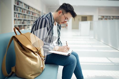 Image of Library, student and college man writing ideas for educational task in notebook with focus. Learning, knowledge and education of smart university guy thinking of assignment with concentration.