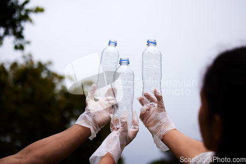 Image of Plastic recycling, sky bottle and volunteer cleaning garbage, pollution or waste product for environment support. Community help, NGO charity and eco friendly people helping with nature park clean up