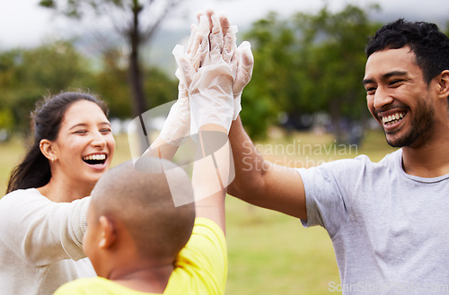 Image of Volunteer high five, happy celebration and community cleaning garbage, pollution or waste product for environment support. Recycle, NGO charity and eco friendly people help with nature park clean up