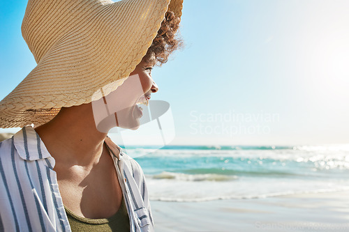 Image of Black woman, smile and beach on summer vacation, holiday or getaway relaxing and enjoying the warm sunny day. Happy female smiling in joy for freedom sunshine, water and travel in relax by the ocean