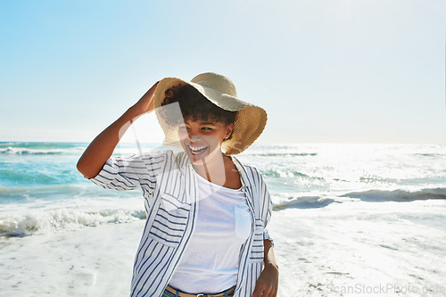 Image of Sunshine, black woman and beach for holiday, relax and fun on trip, travelling or carefree in summer. African American female, lady or seaside vacation, water and stress relief with freedom and ocean