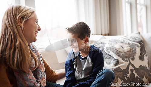 Image of Family, children and love with a mother and son sitting on the sofa in the living room of their home together. Kids, relax and fun with a woman and boy child spending time or bonding in the house