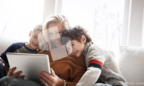 Image of Love, brothers and mother with tablet, sofa and connection for social media, funny videos and bonding in lounge. Boys, motherhood and mama with device, online reading and learning in living room