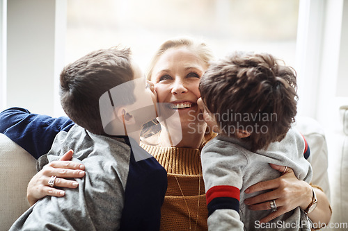 Image of Kiss, bonding and a mother with children for love, relax and playing in a family home together. Hug, smile and mom with affection for boy kids during quality time on the living room sofa of a house