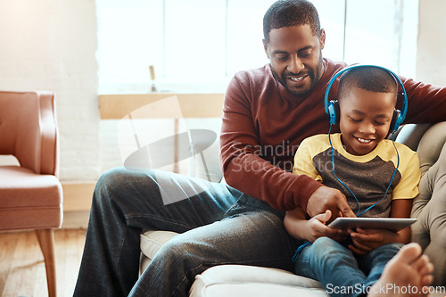 Image of Tablet, relax and father with boy on a sofa watching a funny, comic or meme video on social media. Happy, smile and African man streaming a movie with child on mobile device while relaxing together.