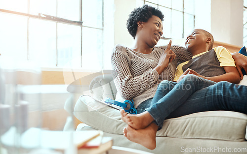 Image of Black family, son and mother relax on a sofa, laugh and happy while bond in their home together. Mom, love and boy resting with parent, content and playful while sitting and talking in living room
