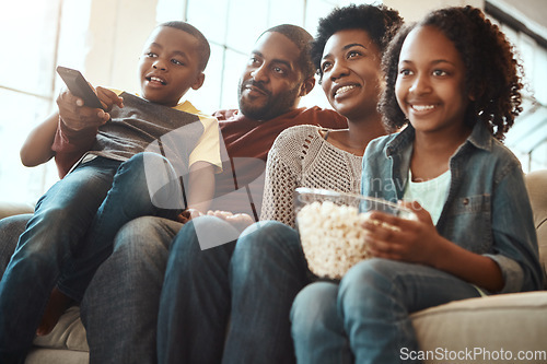 Image of Black family watching tv on sofa for movie, film and cartoon together, bonding and quality time in living room. Popcorn, kids television show of people, mother and father with kids, on couch watching