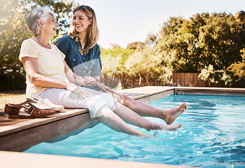 Image of Women relax together by swimming pool, love and care, quality time during summer vacation. Elderly mother, daughter and vacation, content outdoor with pool and wellness lifestyle with happy family