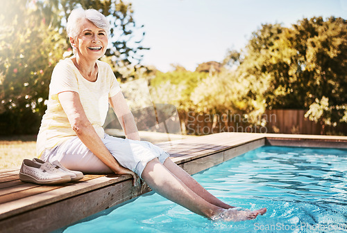 Image of Pool, portrait and senior woman by the water while on a vacation, adventure or outdoor trip in summer. Happy, smile and elderly lady in retirement with her feet in the swimming pool at holiday resort