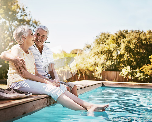 Image of Senior couple, hug and smile by swimming pool for relax, love or quality bonding time together on summer vacation. Happy elderly man holding woman relaxing with feet in water by the poolside outside