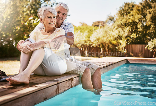 Image of Senior couple, hug and relax by pool for love and summer vacation, bonding or quality time together in the outdoors. Happy elderly man and woman relaxing and hugging with feet in water by a poolside