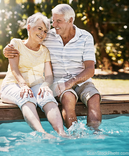 Image of Elderly couple, hug and smile by swimming pool for relax, love or quality bonding time together on summer vacation. Happy senior man holding woman relaxing with feet in water by the poolside outside