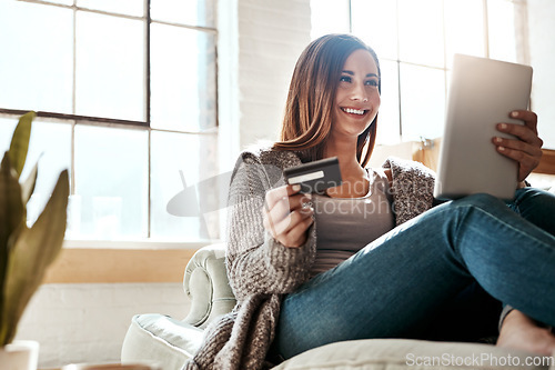 Image of Online shopping, credit card and woman with digital tablet on a sofa, relax and smile while checking booking online. Ecommerce, girl and card for banking, credit score or subscription in living room