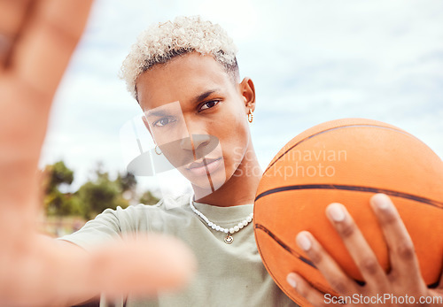 Image of Sports, selfie and basketball player with fashion with a ball standing on an outdoor court. Fitness, edgy and cool man model and athlete from Brazil posing for a picture with a casual outfit in city