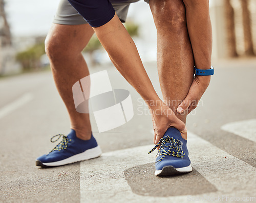 Image of Fitness, pain in ankle and hands of black man with muscle ache, joint pain and injury after running in city. Sports, body wellness and male athlete rest after workout, marathon training and exercise