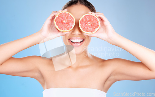 Image of Grapefruit, skincare and wellness of a woman with fruit, cosmetics smile or healthcare face glow. Model, happy or girl with fruits for health, cosmetic and healthy aesthetic facial beauty with food