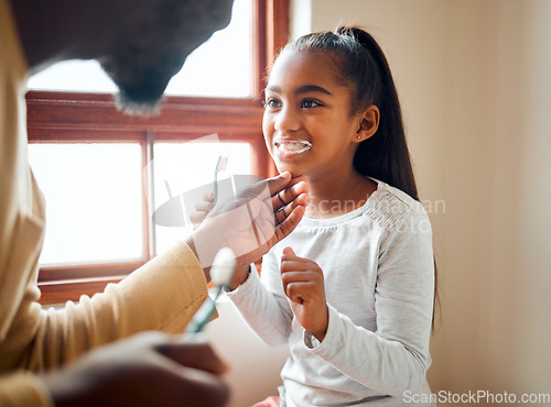 Image of Dental health, father and daughter brushing teeth in a bathroom for hygiene, grooming and bonding. Oral, care and girl with parent, teeth and cleaning while having fun, playful and smile at home