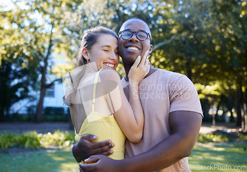 Image of Love, interracial and couple hug in park, bonding and happiness for romance, wellness and quality time together. Romantic, black man and woman embrace, dating and loving for relationship and smile