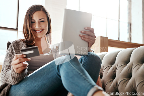 Image of Payment, digital tablet and credit card by woman on a sofa, ecommerce and online shopping in her home. Girl, online shopping and relax checking debit card for purchase or subscription in living room