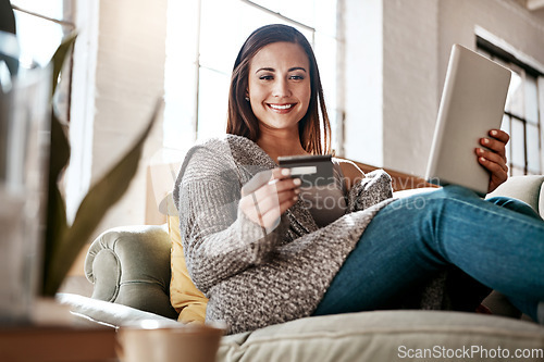 Image of Online payment, digital tablet and credit card by woman on a sofa for online shopping in her home. Ecommerce, banking and girl with debit card for credit score, purchase or payment in living room