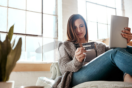 Image of Digital tablet, credit card and woman on a sofa for online shopping, ecommerce and payment while relaxing. Girl, couch and online banking from app, purchase and booking online in a living room