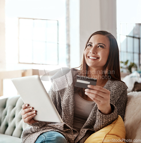 Image of Thinking, credit card and online shopping on digital tablet by woman on sofa for payment or booking online. Idea, girl and online banking with debit card for credit score, purchase and online order