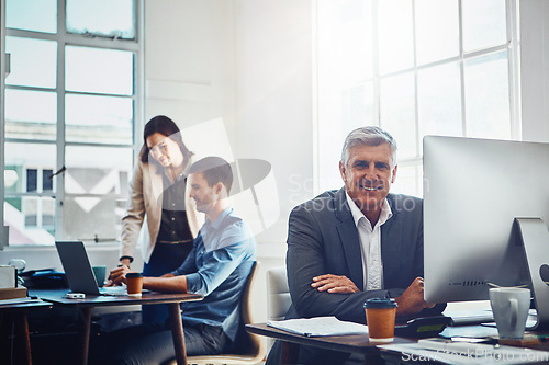 Image of Senior, portrait and business man by computer in office workplace. Pc, coworking and happy elderly male employee working on marketing report, advertising or sales project with colleagues in company.