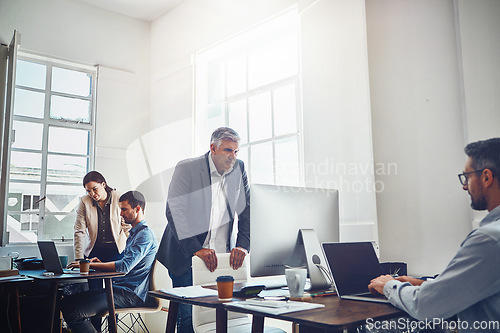 Image of Teamwork, productivity and business people at desk with computer for project, planning and email. Corporate workplace, startup agency and employees sitting at table, in meeting and coworking on ideas