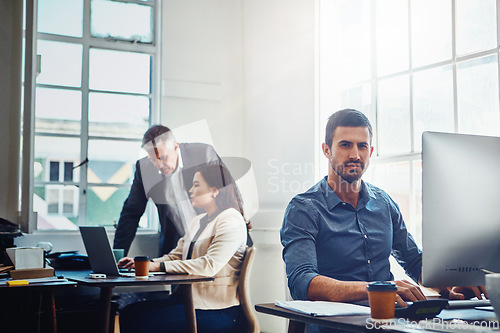 Image of Portrait, office and business man by computer in company workplace. Pc, typing and serious male employee ready for working on marketing report, advertising proposal or sales project with colleagues.