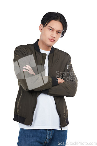 Image of Confident, trendy and portrait of an Asian man with arms crossed isolated on a white background. Fashion, cool and edgy model posing with confidence, tough style and serious on a studio backdrop