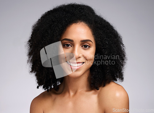 Image of Beauty, portrait and skincare with a model black woman in studio on a gray background for natural skin cosmetics. Face, hair and afro with an attractive young female posing to promote skin treatment