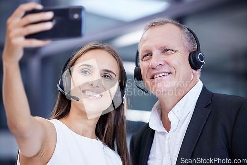 Image of Call center, work and friends phone selfie smile at corporate customer service office in Australia. Workplace friendship and smartphone photograph with senior man and young woman working together.