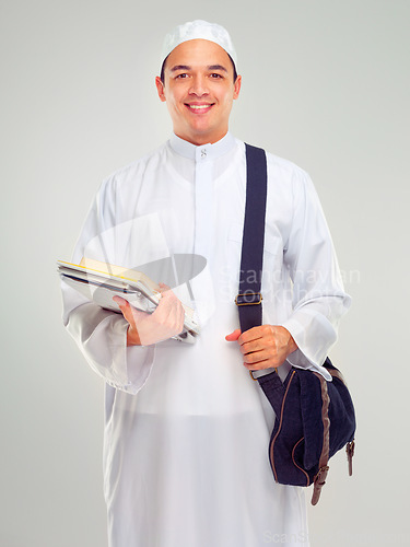 Image of Muslim man, islamic student and standing ready for religious studying, worship or spiritual education in white background. Arabic person, happy and books or culture lifestyle isolated in studio