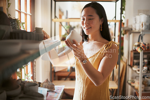 Image of Art, store and creative business woman with pottery, product and startup vision in her studio, happy and smile. Ceramic, sculpture and asian woman excited about dream job and small business in Japan