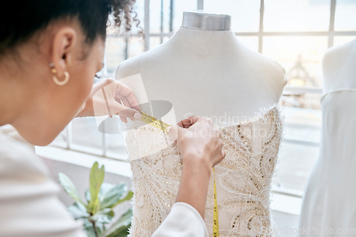 Image of Fashion, designer and woman measuring dress on mannequin. Small business, boutique and female seamstress or tailor with tape to measure clothing, fabric or textile on dummy in workshop or studio.