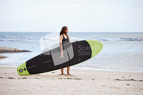 Image of Relax, woman or surfer at a beach on holiday with a surfboard for fitness training, cardio exercise or workout. Freedom, Thinking or sports girl looking at ocean waves for surfing opportunity at sea