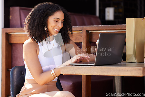 Image of Woman, cafe and laptop with smile, shopping and ecommerce on internet sale, discount or deal. Black woman, happy and coffee shop with online shopping, computer and web to search, clothes and fashion