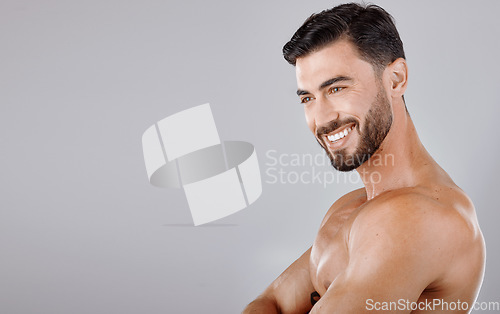 Image of Man, face and smile with beauty and skincare, muscle and glow with cosmetic skin treatment against studio background. Grooming, hygiene and body cleaning mockup with natural cosmetics and wellness