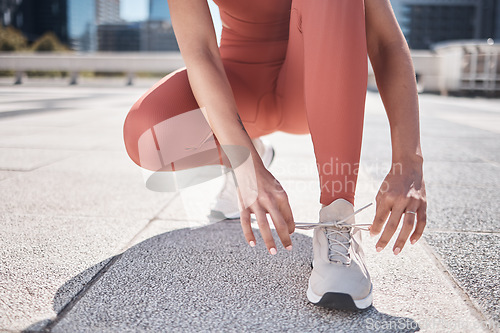 Image of Hands, fitness and black woman tie shoes getting ready for training in city. Workout, sports athlete and female runner tying sneaker lace and preparing for jog, running or exercise outdoors on street