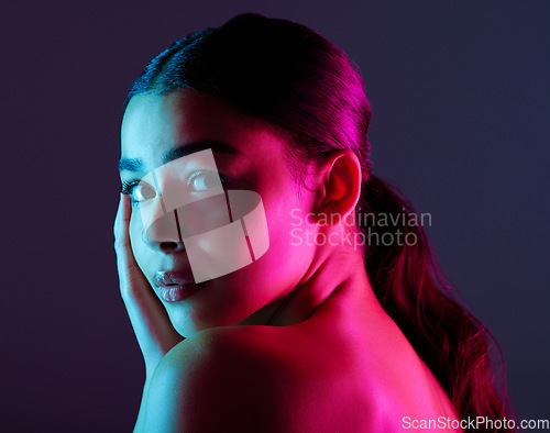 Image of Beauty, neon shadow light and portrait of woman with dark lighting, facial cosmetics and skincare glow. Luxury studio makeup, aesthetic creativity and face model with creative pink blue color design