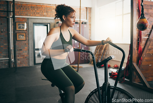 Image of Exercise bike, fitness and woman at gym for workout, cardio training and cycling for energy, balance and lose weight. Sports female or athlete with spinning machine for health, wellness and self care