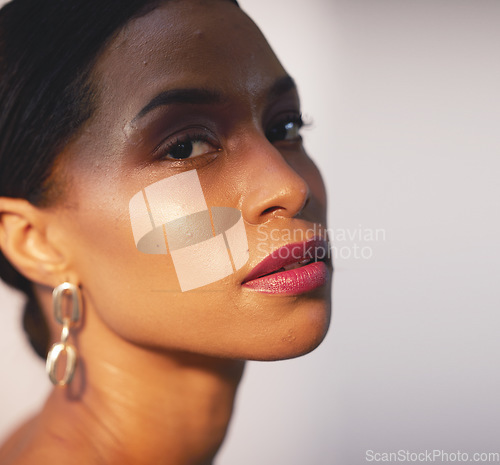 Image of Portrait, beauty and skincare with a model black woman in studio on a gray background for natural care. Face, cosmetics and wellness with an attractive young female posing to promote a luxury product