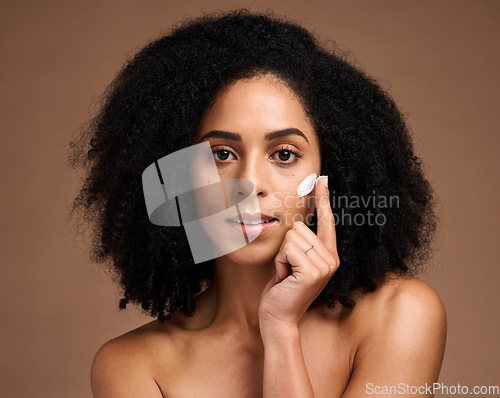 Image of Skincare, cream and black woman in portrait for facial, beauty and cosmetics promotion of product in studio. African model with skin care, dermatology or sunscreen application on face