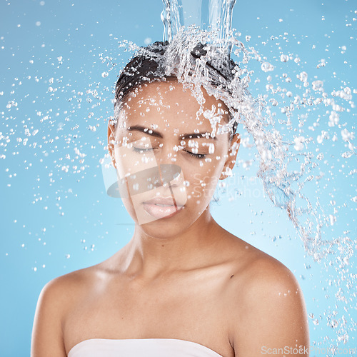 Image of Woman, washing hair or water splash skincare on blue background studio in healthcare wellness, dermatology grooming or hygiene cleaning. Beauty model, wet or water drops in bathroom shower hair care