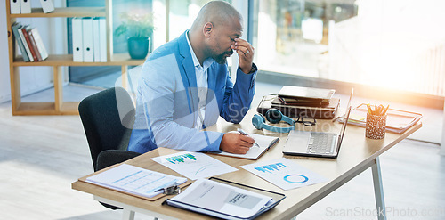 Image of Burnout, laptop or corporate black man with headache in office with tax finance or company audit stress with lens flare. Sad, documents or employee with mental health, depression or financial anxiety