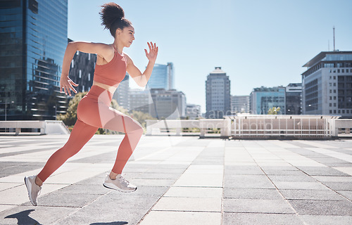 Image of Fitness, city and woman running for exercise, health and wellness. Sports runner, energy and female athlete exercising, cardio or training workout outdoors on street for race, marathon or endurance.